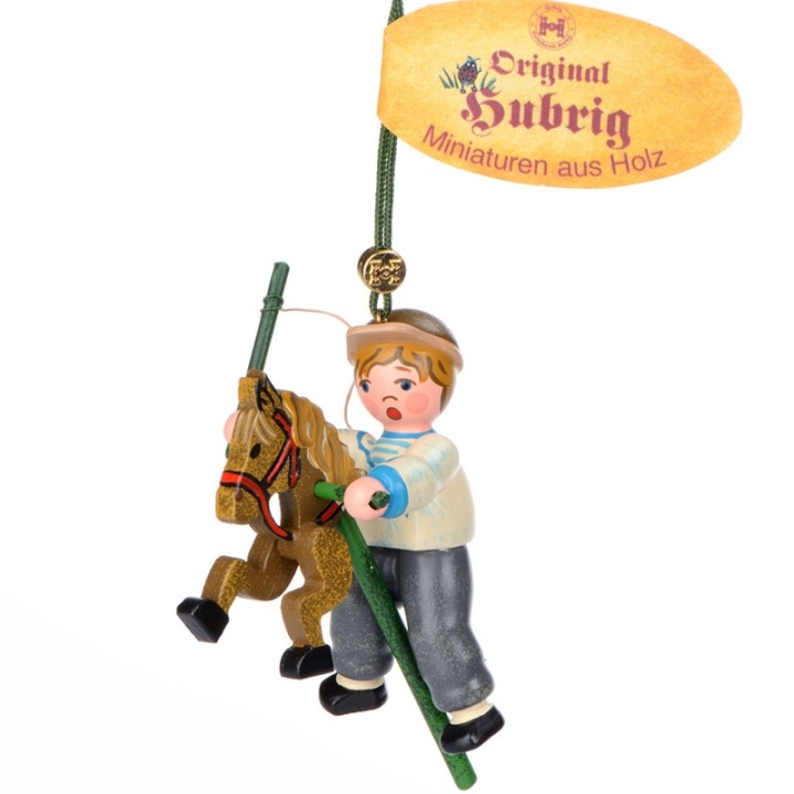 Noël d'autrefois, petit garcon sur un cheval en bois