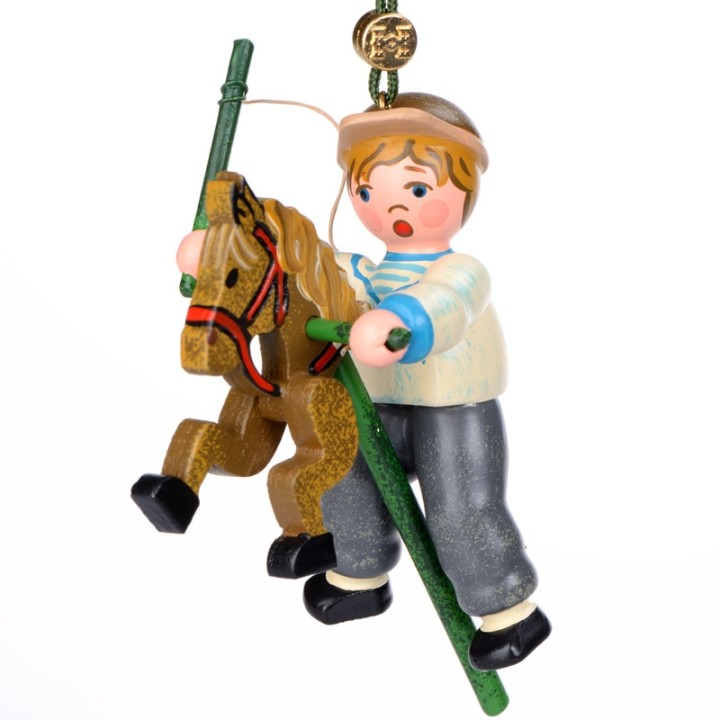 Noël d'autrefois, petit garcon sur un cheval en bois