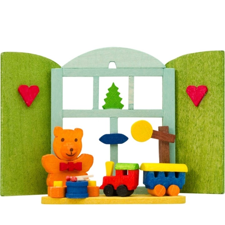 Décoration de sapin de Noël, ourson et petit train devant fenêtre