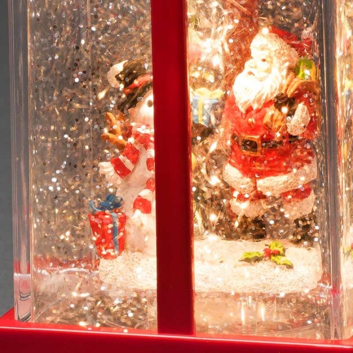 Lanterne à neige "Cadeau de Noël" avec Père Noël & bonhomme de neige