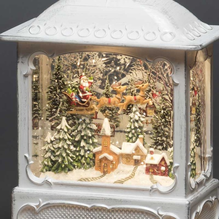 Lanterne de Noël blanche, père Noël volant au-dessus d'un village
