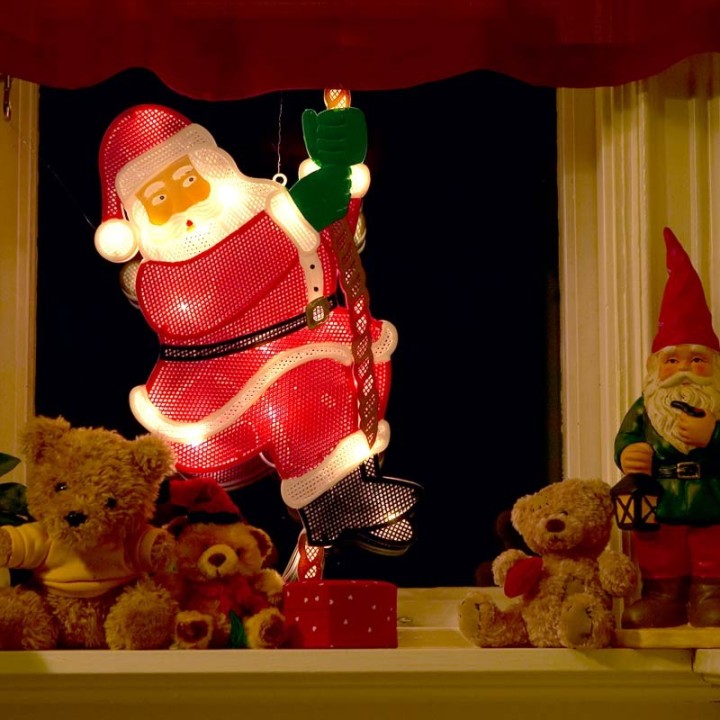 Père Noël lumineux grimpeur sur une corde