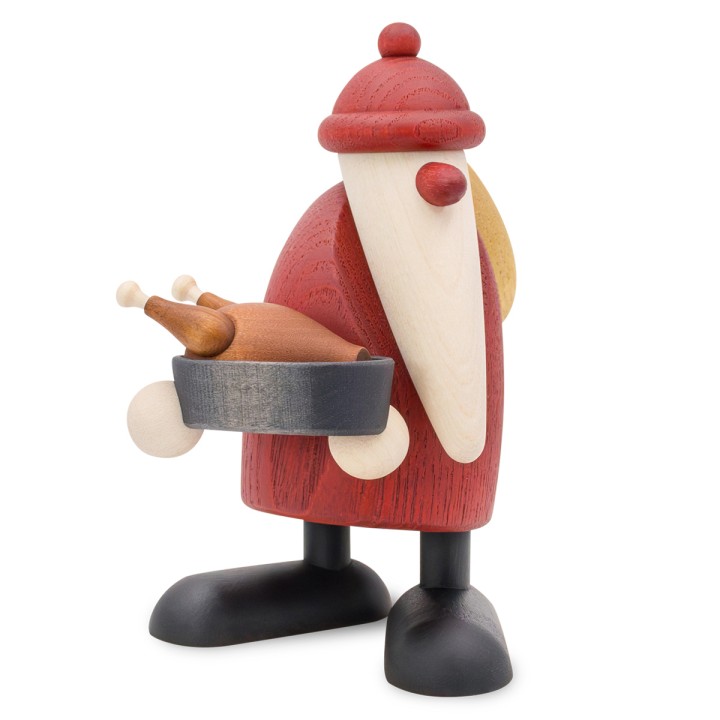 Père Noël en bois tenant une poêle avec un rôti d’oie doré